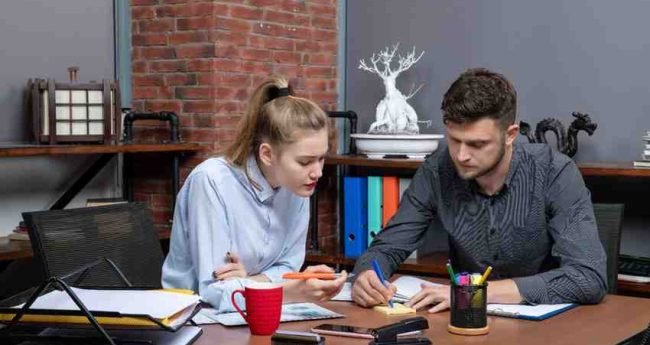 Student organizing paragraph cards on a desk to practice PTE Reorder Paragraphs strategies for the Australia exam